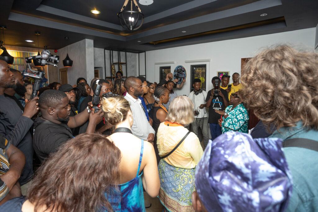 A crowd of attendees and photographers gathered inside the residence during the festival